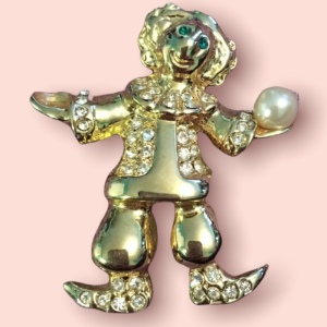 Gold tone clon juggler crystal brooch