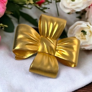 Large Heavy gold finish metal BOW brooch Etienne Aigner