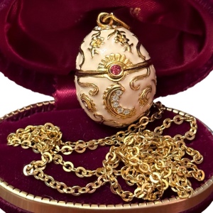 Gold finish creamy enameld crystal embellished Faberge style egg locket necklace