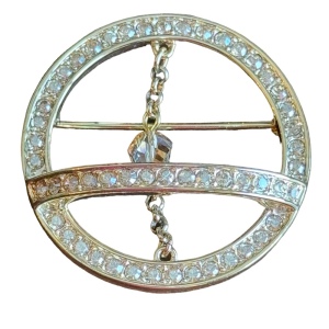 Swarovski gold circle brooch a pave of clear crystal and features a small chain